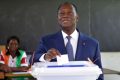 Ivory Coast's President Alassane Ouattara casts his vote in the ballot box, at a polling station in Abidjan, on October 30, 2016, during a vote for a referendum on a new constitution. Voters in Ivory Coast went to the polls on October 30, 2016 to determine the fate of constitutional changes that President Alassane Ouattara says will help end years of instability and unrest linked to the vexed issue of national identity. / AFP / SIA KAMBOU